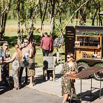 Outdoor event being served by vintage mobile bar